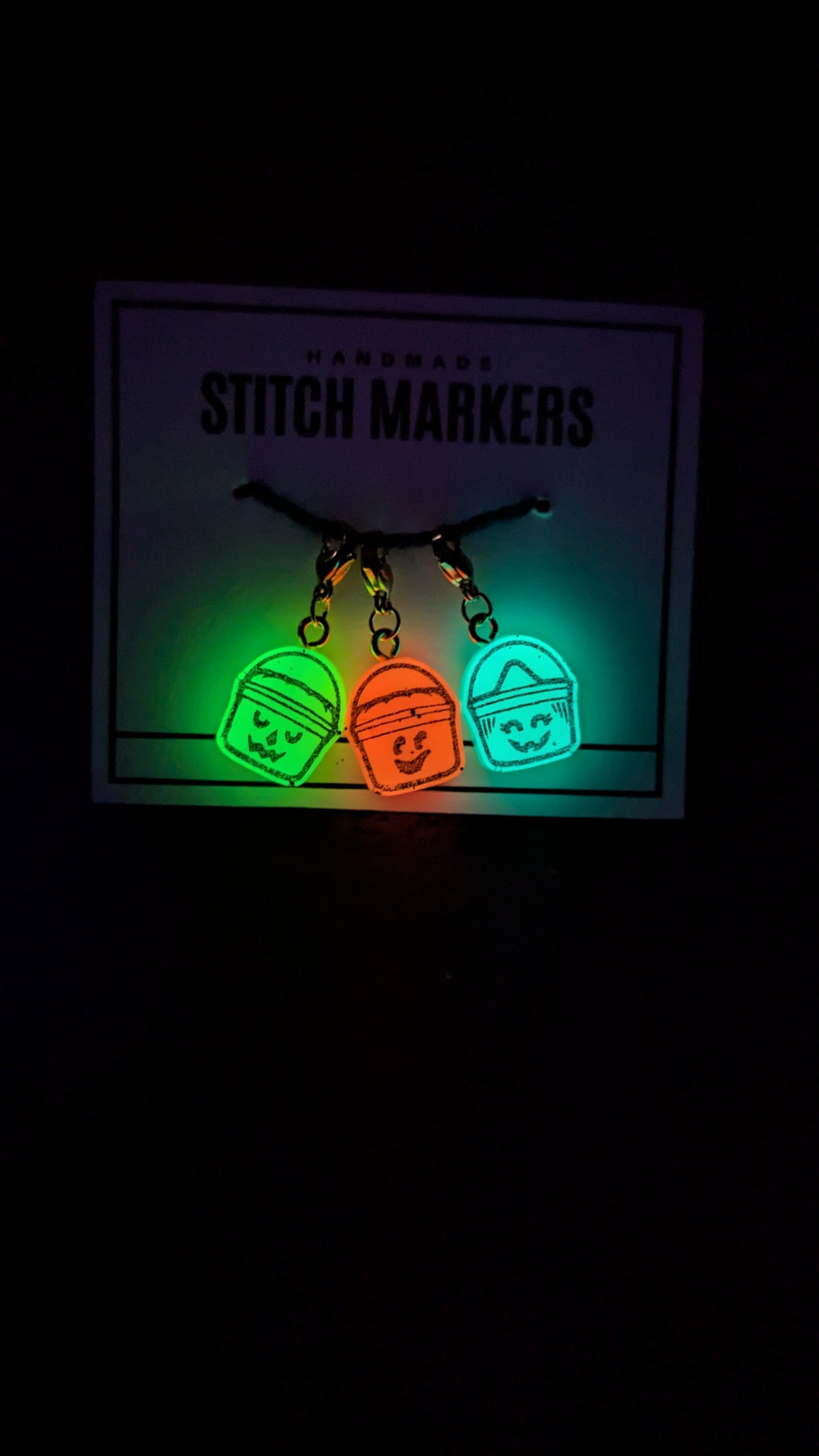 Three glowing stitch markers on a dark background with 'Stitch Markers' text.
